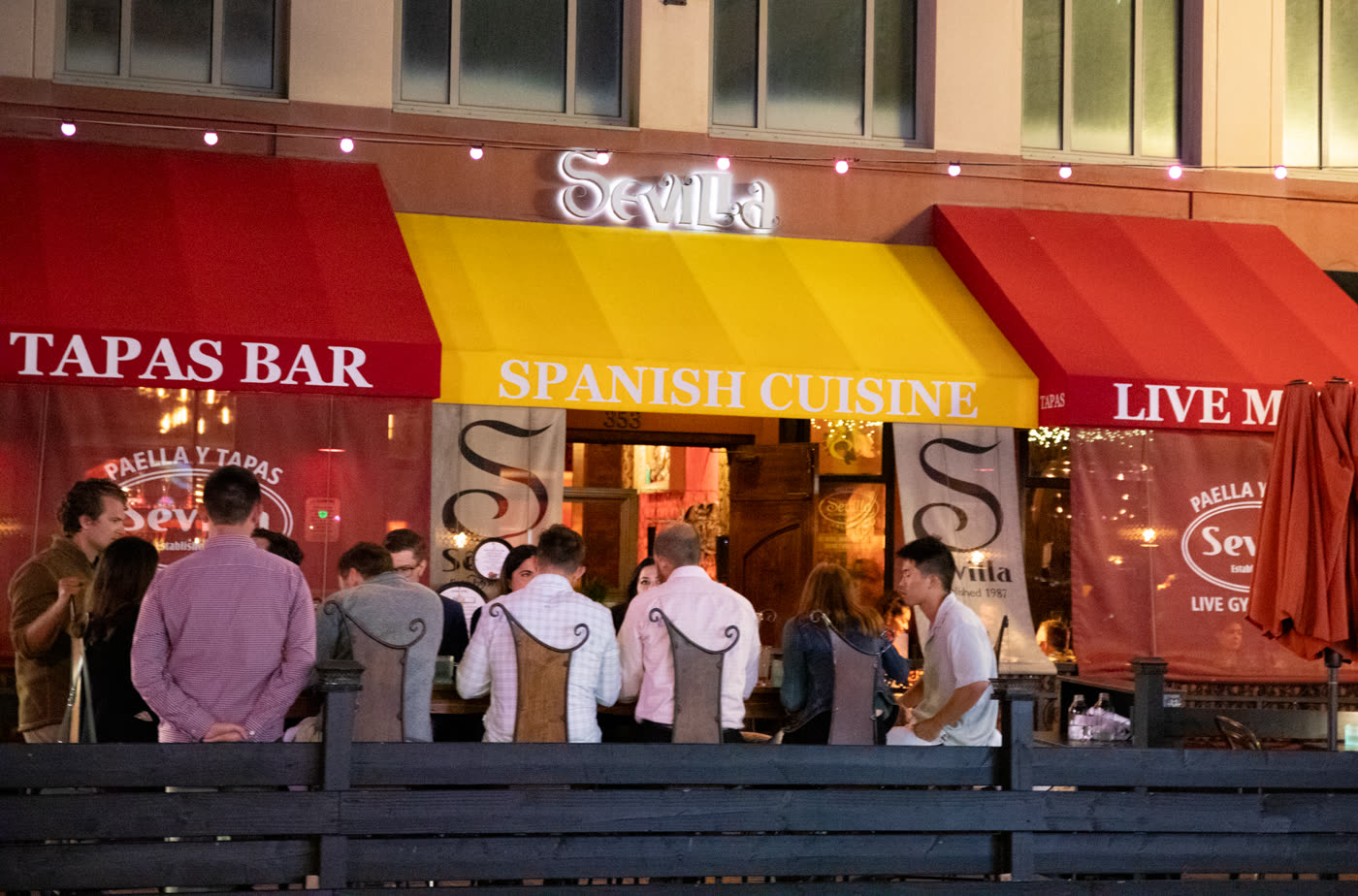 Patio dinner under the Tapas Bar awning after dark.