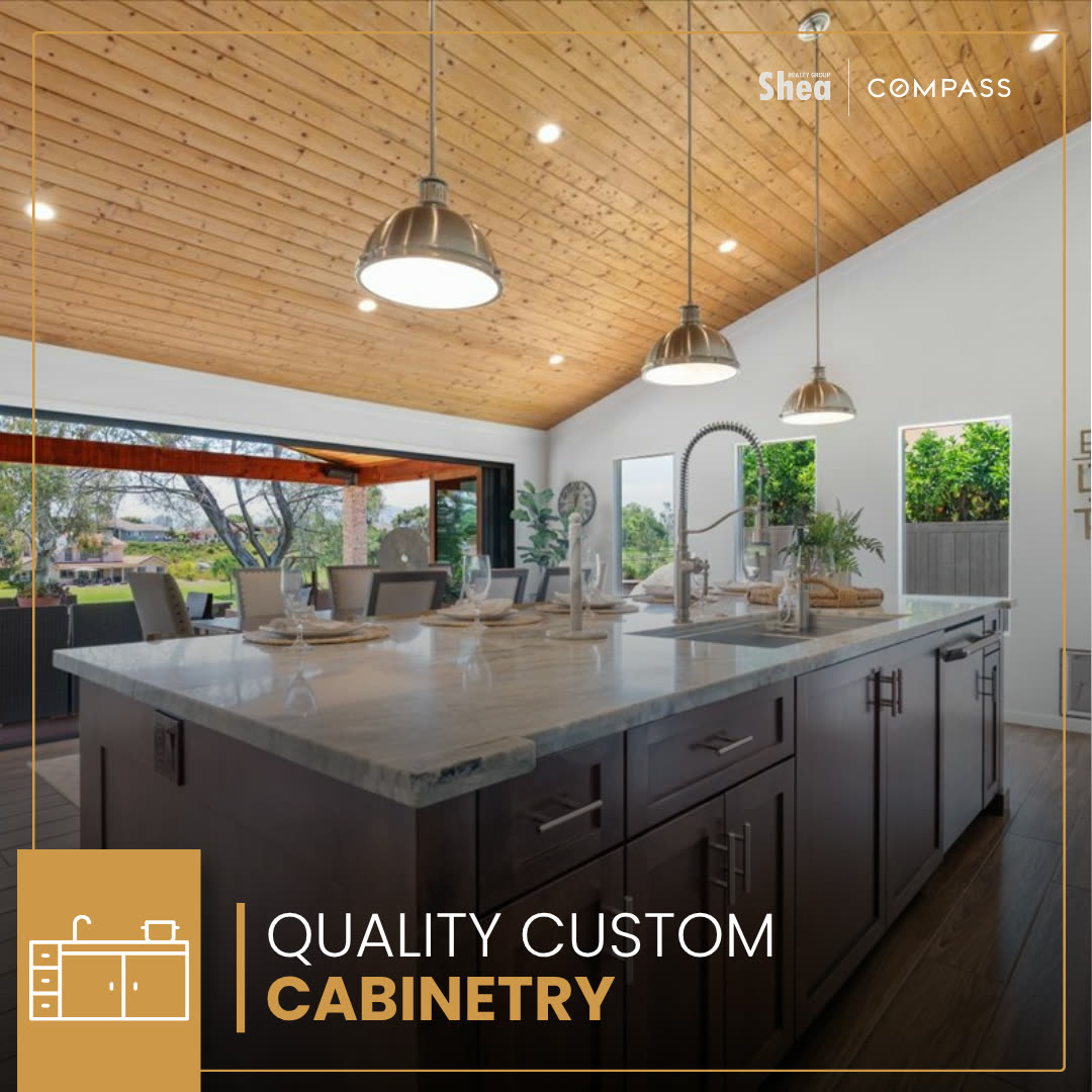 Feature slide on the custom cabinetry under a wood-lined kitchen ceiling.